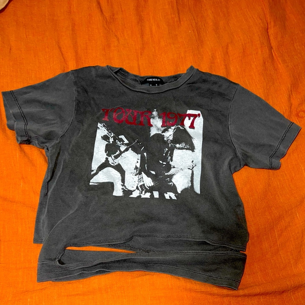 Dark grey wash crop top, says “tour 1977”